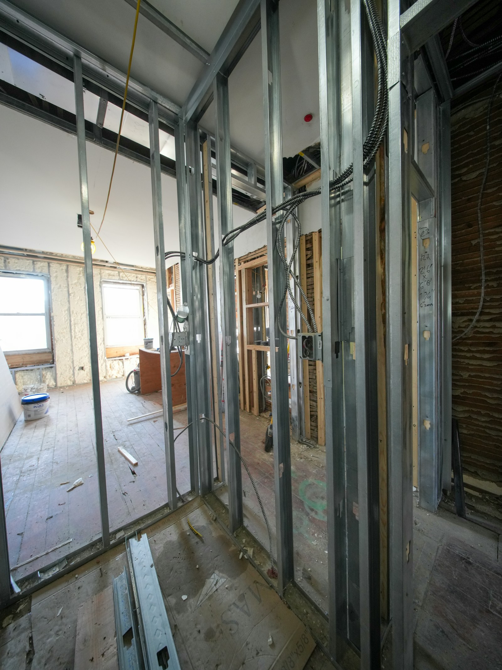 Rough-in electrical wiring running through open wall framing during a renovation